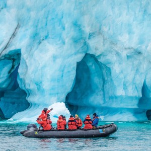 Image with individuals in a boat promoting Land of the Ice Bears travel program