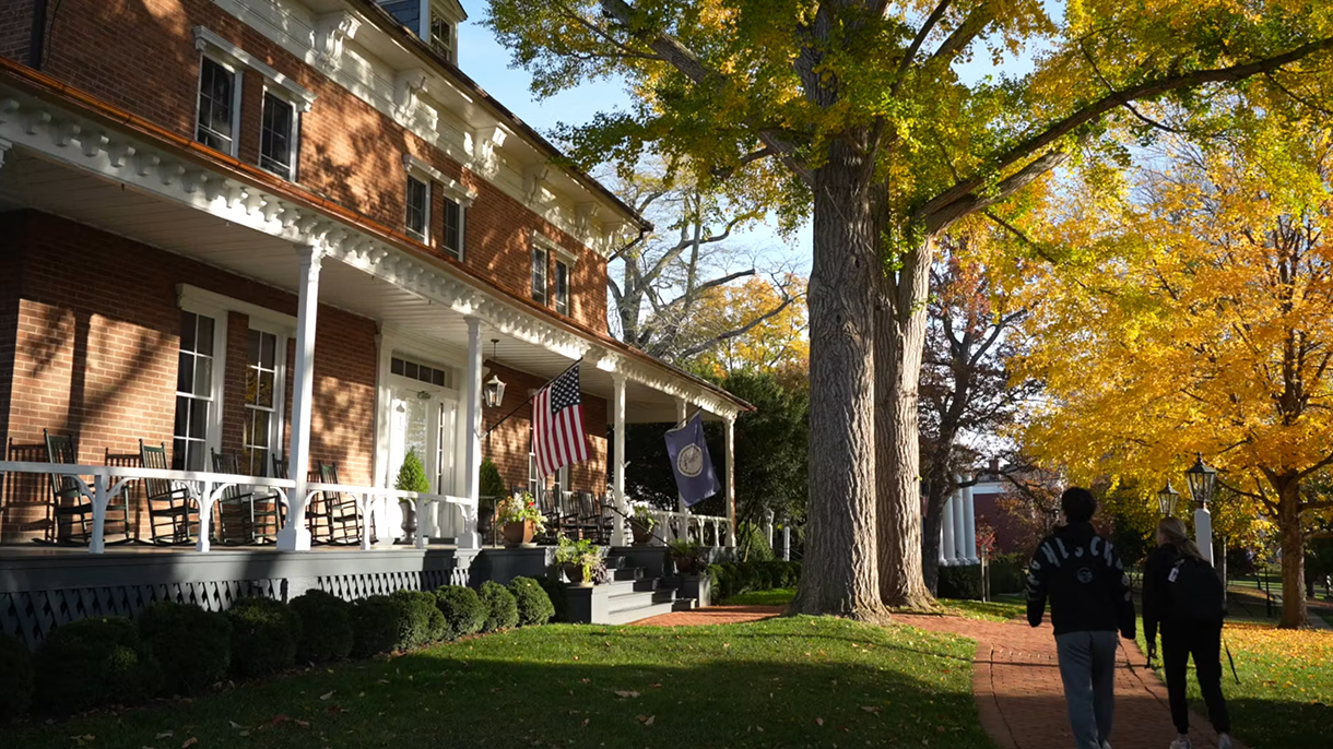 Students walking in front of Lee House on campus.