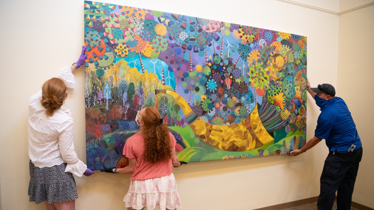 Students setting up Chaos in Color exhibit pieces