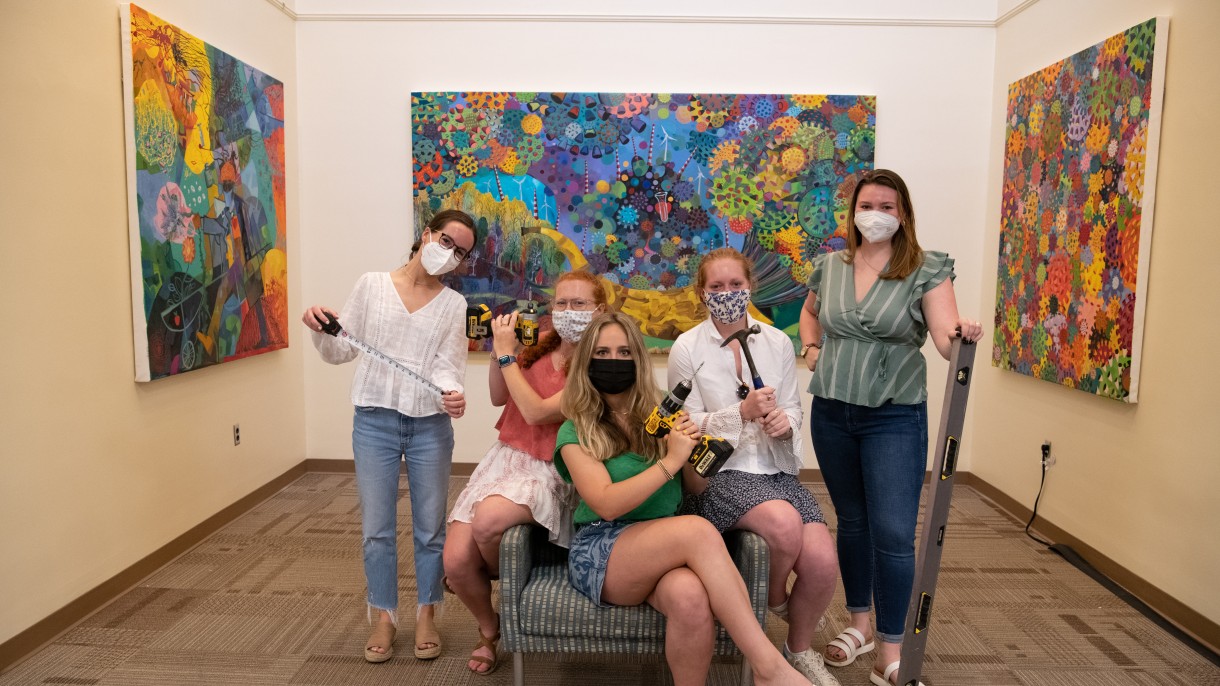 Students setting up Chaos in Color exhibit