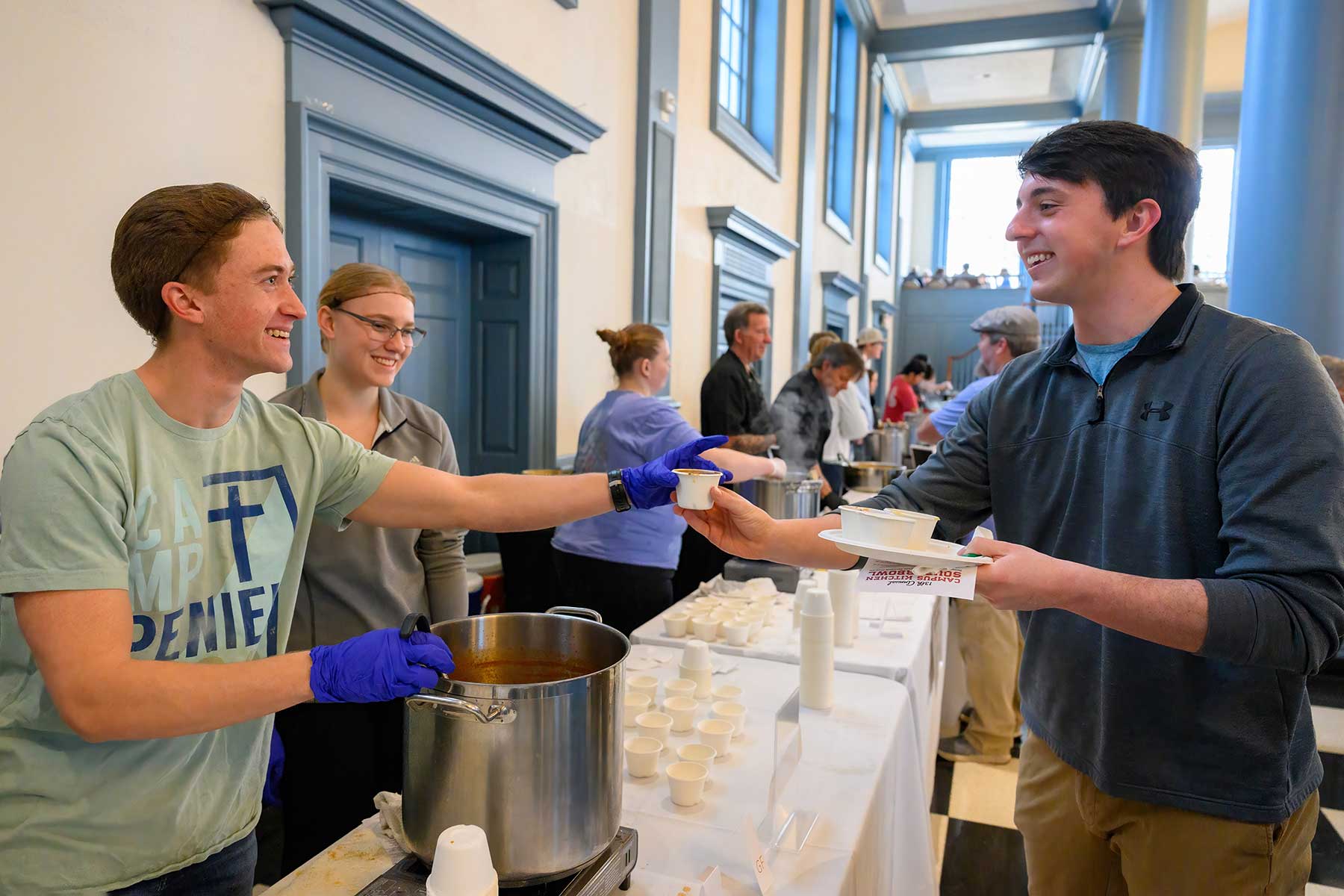 Students serve soup at the Souper Bowl in Evans Dining Hall