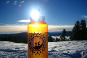Water bottle with an Outing Club logo on it in the snow