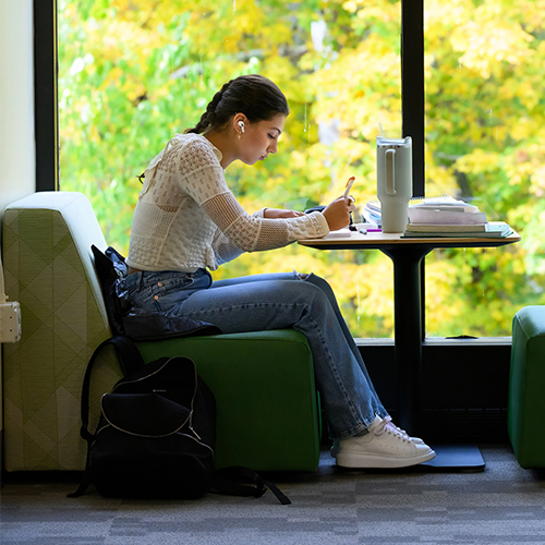 Student writing in the Harte Center