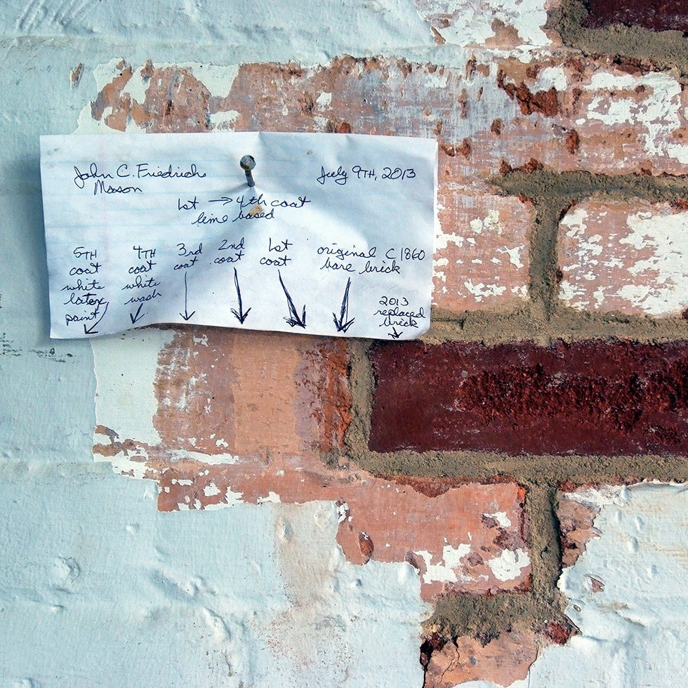 Brick wall with exposed layers and excavation notes