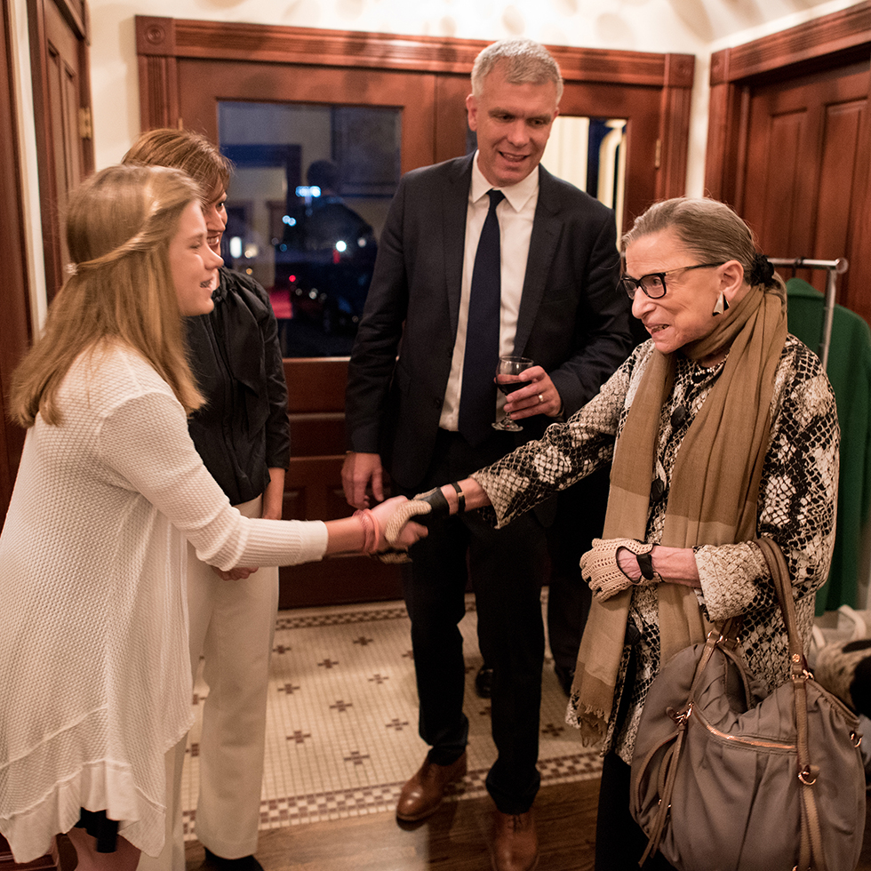 A student shakes Ruth Bader Ginsburg's hand