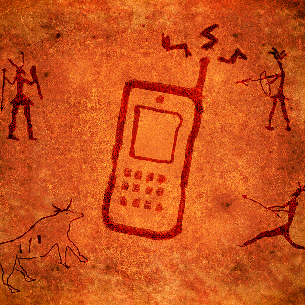 A cell phone in the middle of stone drawings