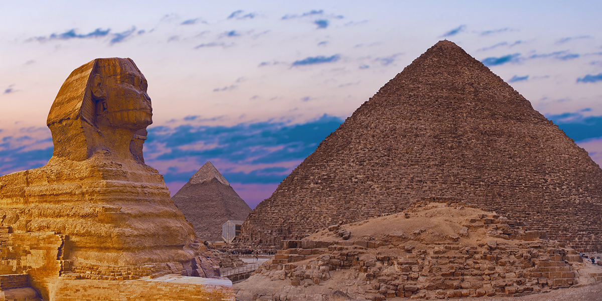 Sphinx against the backdrop of the great Egyptian pyramids. Image by Mountains Hunter.