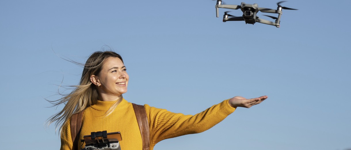 Banner image of an individual flying a drone