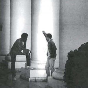 An image of students talking at the columns of the Colonnade