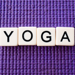 An image of YOGA spelled out on a yoga mat