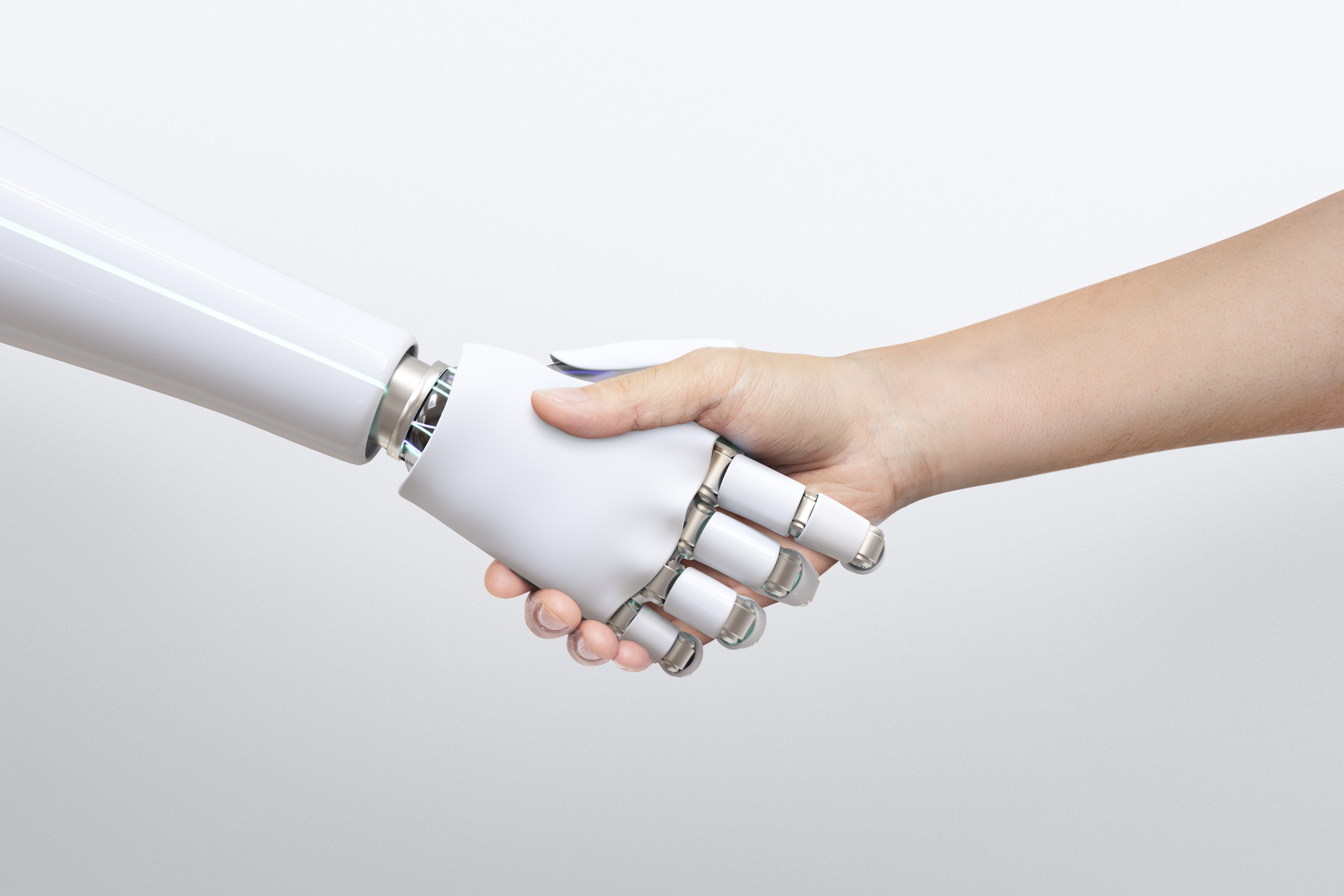 A robot hand shaking a human hand to promote The Imitation Game: Artificial Intelligence and Human Position