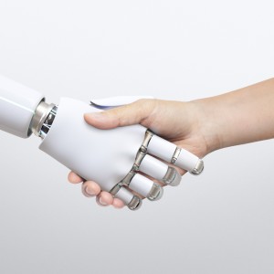 Image of a robot and human shaking hands 