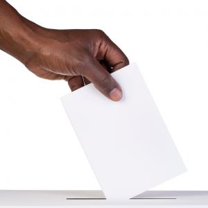 An image of a hand casting a ballot