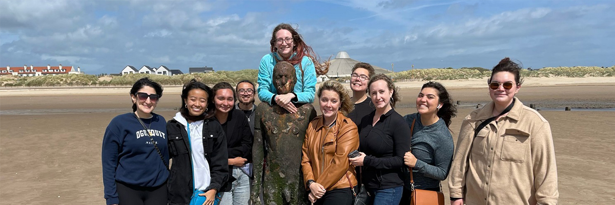 Image of a group of students on a beach in England. 