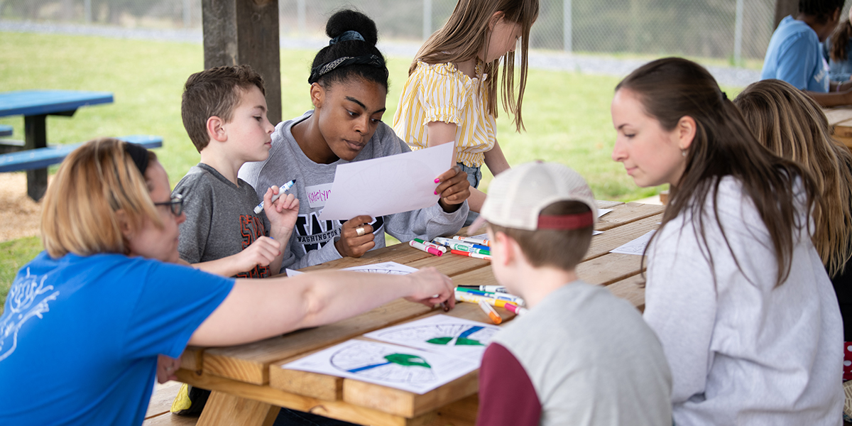 Undergraduate students working with local students