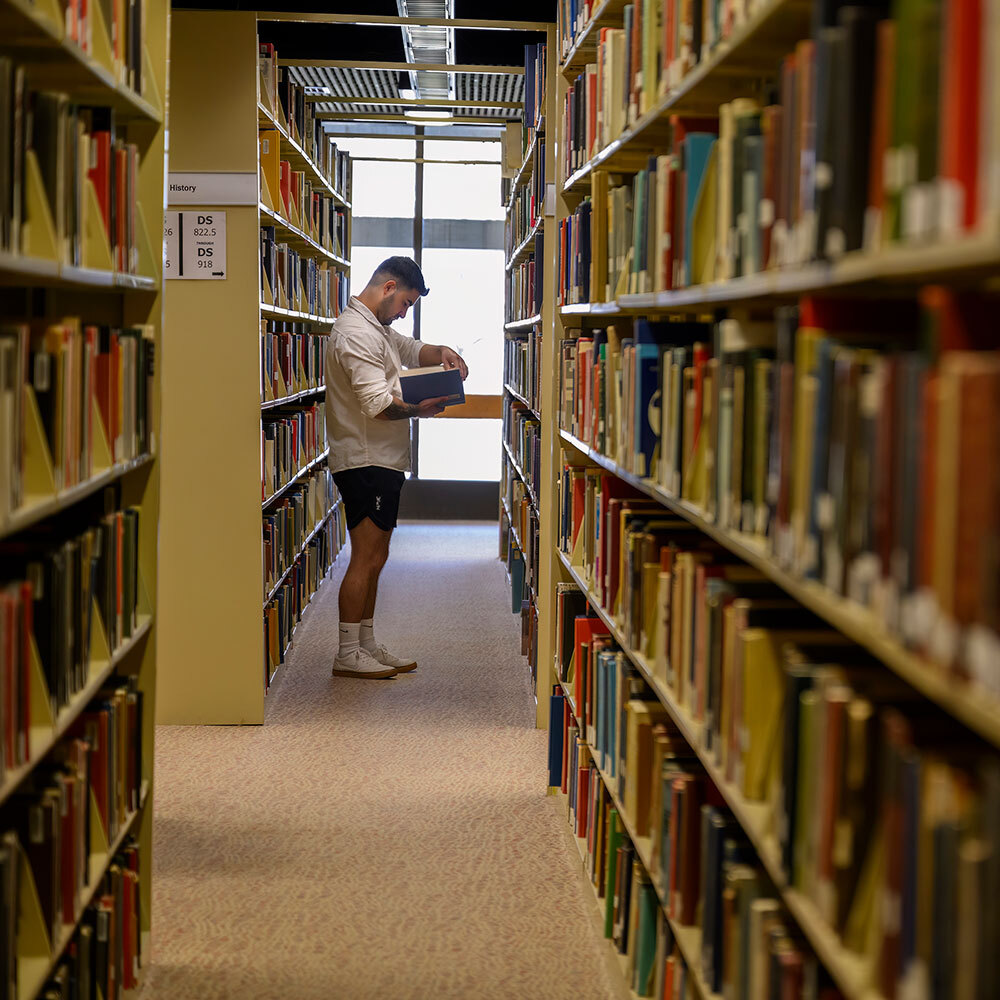 Student in the library stacks