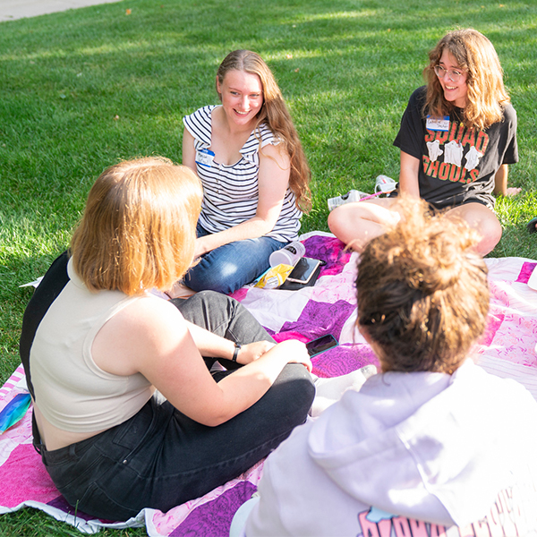 Students on a blanket at the LGBTQ Picnic