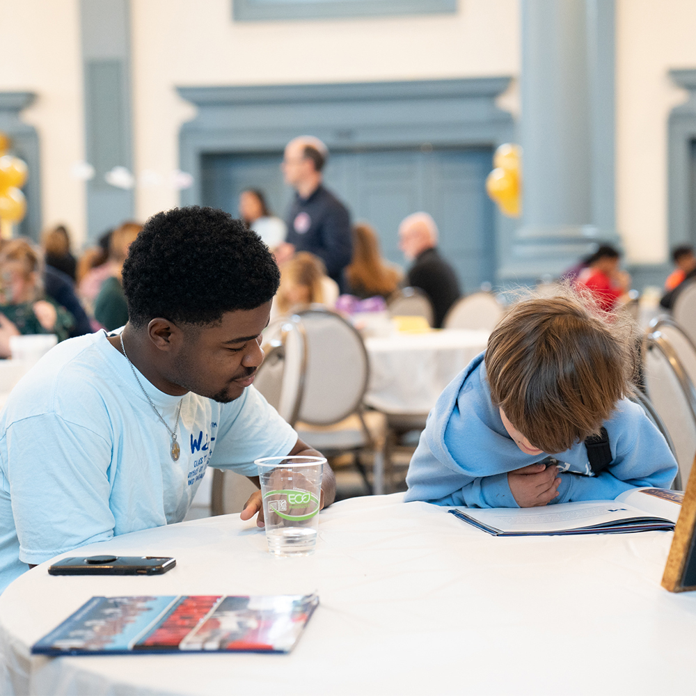Student leads a reading activity during the Children's Celebration in honor of Dr. Martin Luther King Jr.