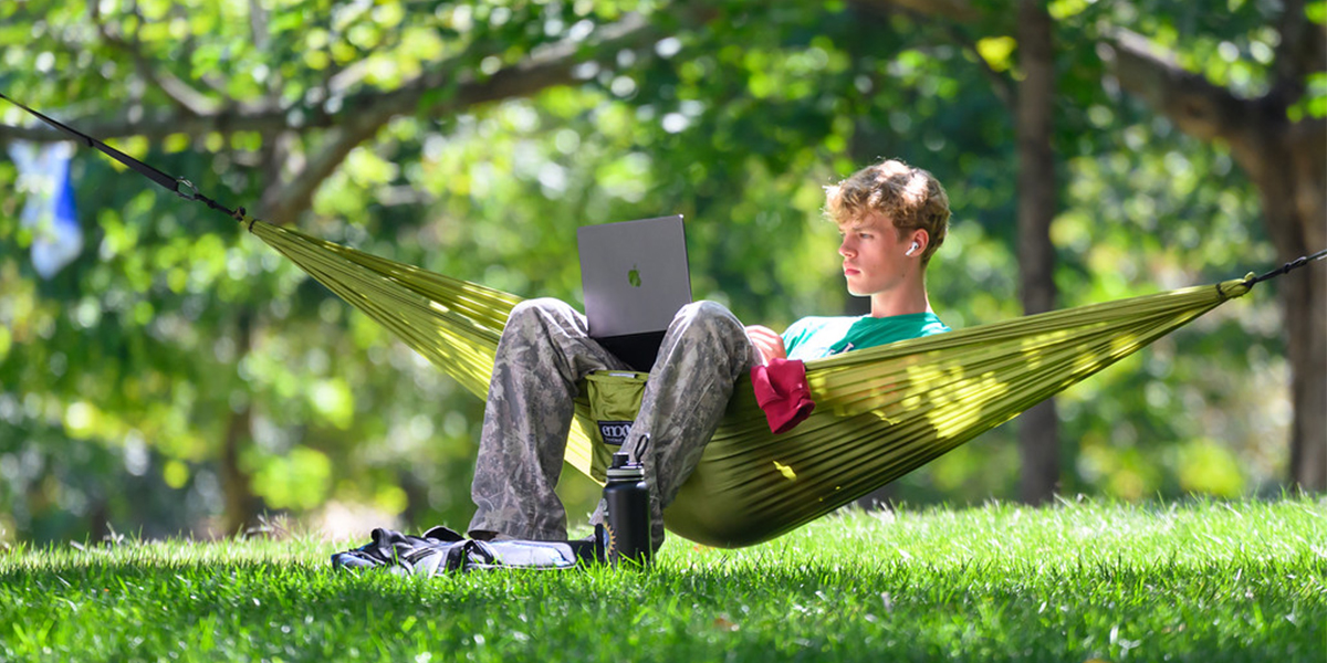 Student studying in hammock